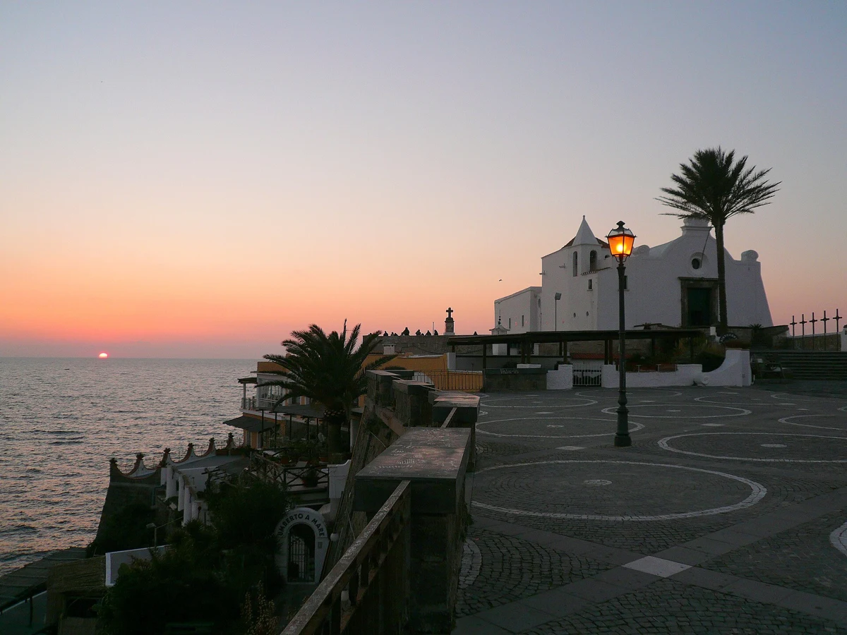 Chiesa del Soccorso at sunset above Forio, the skyline of the private sunset boat tour in Ischia, Campania, Italy